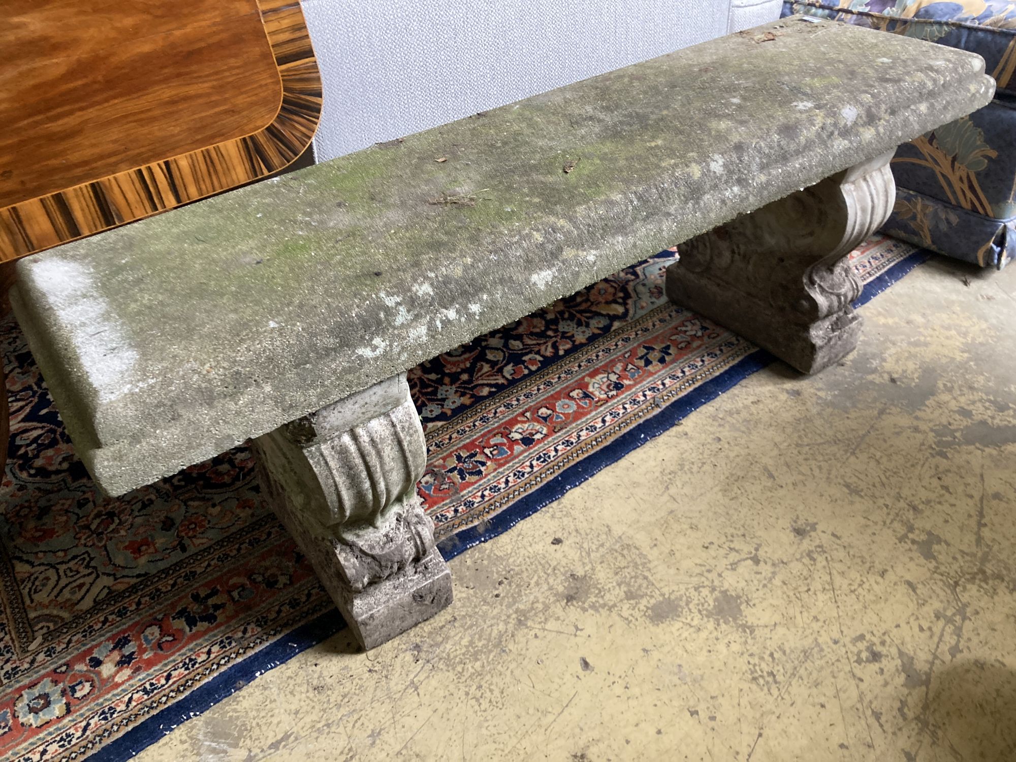 A reconstituted stone garden bench seat, length 126cm, depth 38cm, height 45cm